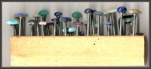 Nails set loosly in drilled holes in wood block