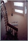 Stairs with multple skylights in a high Vulted Ceiling